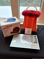 All three items: boxed Sonic Bomb alarm clock, purse lamp, nutrition scale