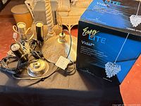 Boxed Z-Lite Vida pendant, Mercury disc fixture, three plug-in spotlights with cords on tabletop