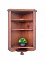 Front view of pine corner wall shelf displaying overall design and scale