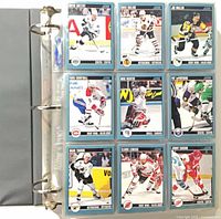 binder open showing nine 1992 Score hockey cards in 9-pocket page
