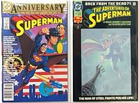 Both Superman comic issues in protective bags