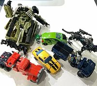 Group shot of all six Transformers in vehicle/beast modes