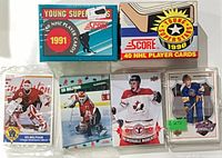 Full lot overview showing both Score boxes, sealed Belfour card, Score pack, Toews stack and Brett Hull sets