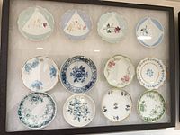 Front view showing all 12 butter pats mounted in frame