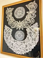 Full view of framed lace pieces