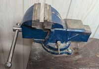 Full view of blue bench vise attached to workbench