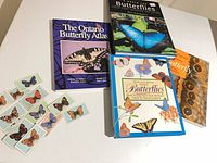 Overall lot showing four butterfly books and loose Wills collector cards