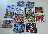 Front view of all 13 patterned tiles laid out