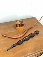 Lot overview showing two carved snakes and inlay box on table