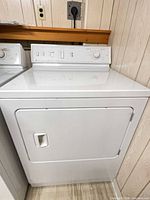 Full view of Maytag white dryer front and side