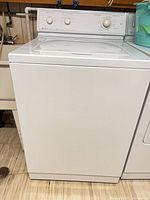 Front view of white Maytag top-loading washing machine