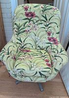 Full view of floral upholstered swivel rocker