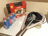 Boxed Iwatani stove, four fuel canisters, landing net