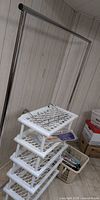 Garment rack frame, five-tier shoe rack, laundry basket with hangers visible