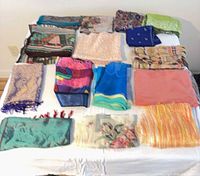 All fifteen scarves laid out on bed