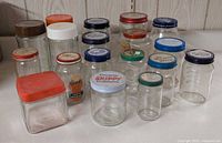 Group shot showing all 18 glass jars with various lids