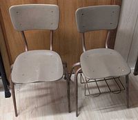 Front view of both vintage school chairs