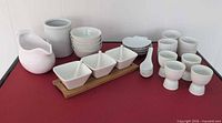 Full set of white porcelain serving ware on table