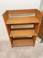 Front view of wood composite three-shelf bookcase