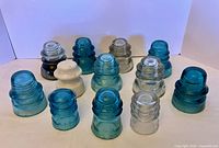 Group shot of 12 antique glass and ceramic insulators