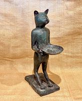 Front view of standing cat sculpture with tray