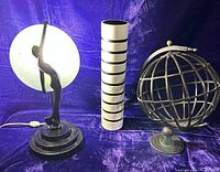 Front view of lamp, vase and metal sphere