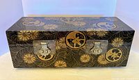 Front and top view of black lacquered wood box with gold floral and butterfly motifs
