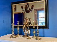 Group shot of mirror, five candlesticks, plaster minstrel