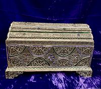 Front view of silver filigree jewelry box showing wirework and stone inlays