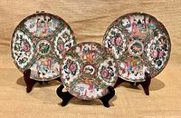 Front view of three Rose Mandarin plates on stands