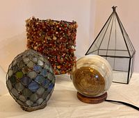 Group shot of beaded cylinder shade, stained-glass dome, alabaster globe lamp, and glass pyramid cover