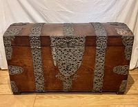Front view of oak trunk with ornate iron straps