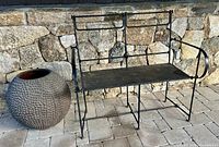 Settee and Lobi pot side by side against stone wall