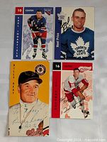 Four signed NHL cards laid out