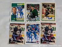 Six autographed hockey cards displayed in two rows