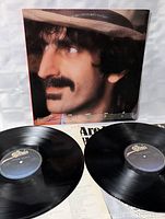 Front cover with portrait and two vinyl discs