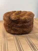 Front/side view of mink pillbox hat showing fur texture and shape