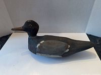 Left profile of carved wooden duck decoy