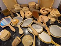 Overview of all cream French-ivory vanity items spread on surface