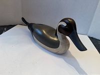 Top and side view of wooden bird showing paint and carving detail