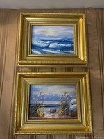 both framed paintings stacked vertically
