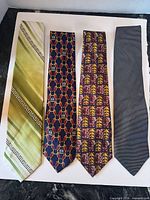 Four neckties laid flat showing full length and patterns