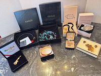 All eight boxed jewelry items displayed