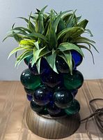Front view of glass grape lamp with foliage and base
