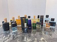Full group shot of approx. 18 assorted men’s fragrance bottles and sprays