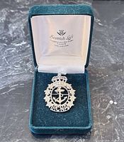 Brooch inside open Scottish Loft box showing insignia and stones