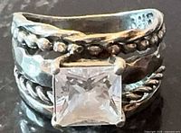 Front view showing square clear stone and multi-band detailing