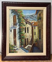 Front view of framed Mediterranean village oil painting