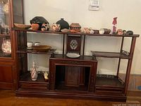 Front view of entire rosewood display shelf