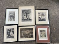 Group shot of six framed etchings laid out on ground
